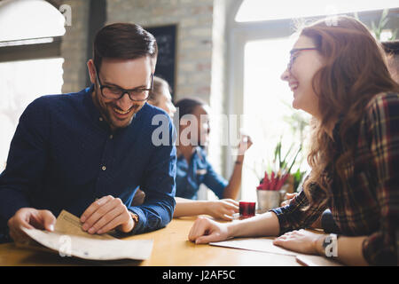 Flirting coworkers eating out and dating in restaurant Stock Photo - Alamy