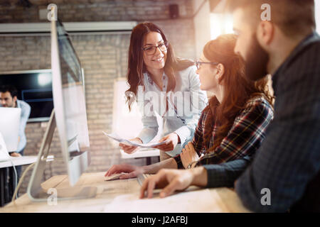 Happy creative coworkers working in designer office Stock Photo