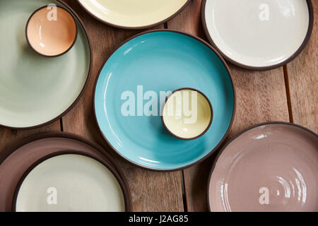 Handmade earthenware on a wooden table, overhead close up Stock Photo