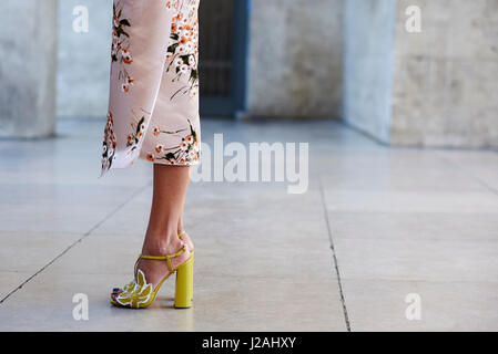 Low section of woman in silk kimono dress and yellow heels Stock Photo