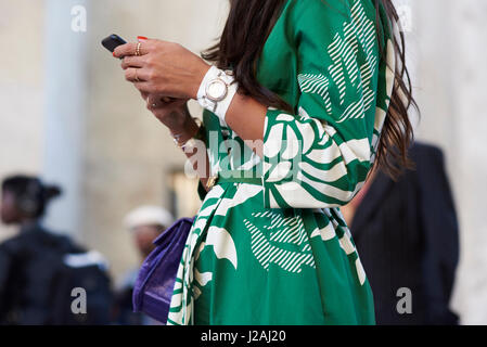 Mid section of woman in green kimono inspired wrap-over dress Stock Photo