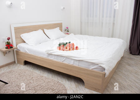 bedroom in soft light colors. big comfortable double bed in elegant classic bedroom Stock Photo