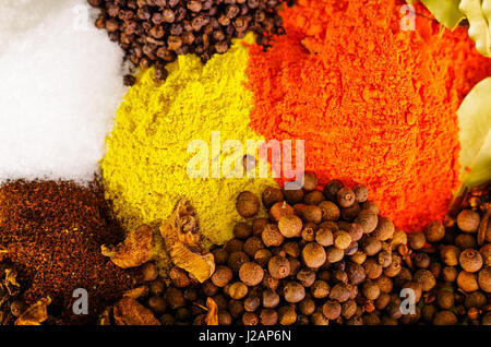 Closeup from above different piles of colorful spices, beautiful rustic setting, spice and herbal concept Stock Photo