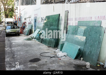 Many sheets of glass stacked behind a builidng in Kuala Lumpur, Malaysia Stock Photo