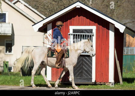 Brakne Hoby, Sweden - April 22, 2017: Documentary of small public farmers day. Young female archer on horseback. Stock Photo