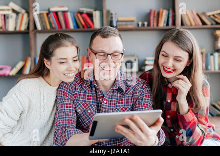 Hipster friends looking at their selfie on tablet. Stock Photo