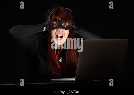 Woman steals information from computer Stock Photo