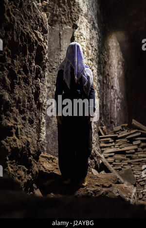 Full length of woman with obscured face standing in cave Stock Photo