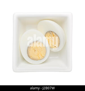 Hard boiled egg in a square bowl isolated on white background Stock Photo
