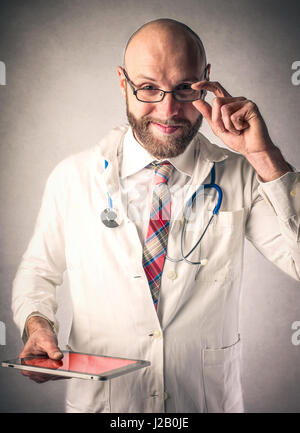 Bearded doctor looking into camera Stock Photo