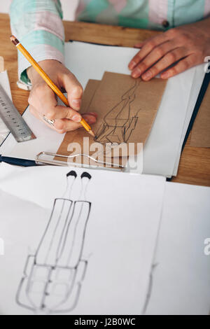 High angle view of female designer drawing sketch on paper at studio Stock Photo