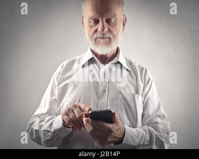 Old man using mobile Stock Photo