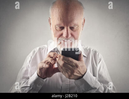 Old man using mobile phone Stock Photo