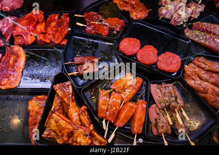 Marinaded meat for grilling in a counter display in a supermarket.  meat at the butcher Stock Photo