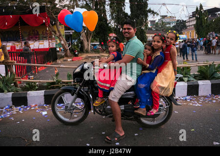 A father attends with his daughters to the carnival parade Stock Photo