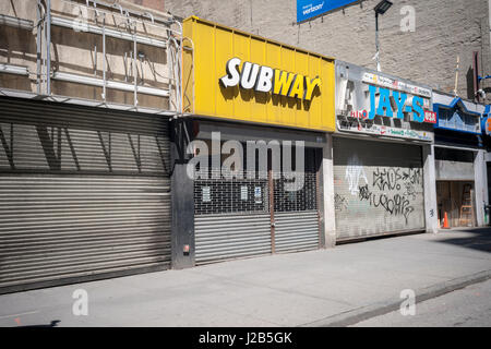 Vacant storefronts in a taxpayer, including a Subway sandwich shop, are seen in New York in a building ready for demolition on Sunday, April 23, 2017. (© Richard B. Levine) Stock Photo