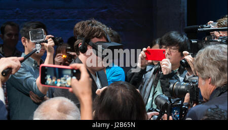 Oculus Founder Palmer Luckey wears the Oculus Rift consumer version Virtual Reality goggles is surrounded by photographers during a demonstration at the Silicon Valley Virtual Reality Expo June 11, 2015 in San Jose, California. Stock Photo