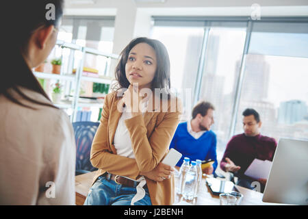 Shocked business woman listening to news Stock Photo