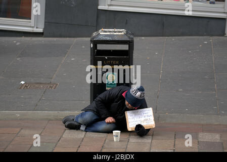 homeless in the uk begging on the street bod issue seller selling litter garbage rubbish Stock Photo