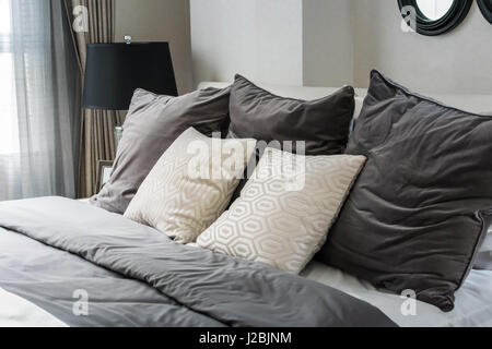 white and grey pillows on bed in modern bedroom Stock Photo