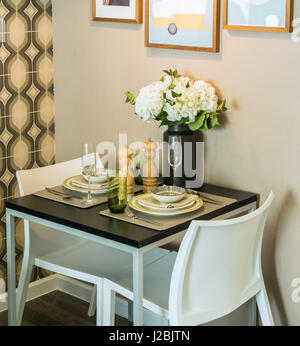 table set with chairs in dinning room Stock Photo