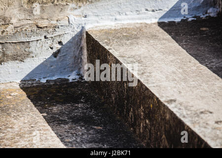 Abstract weathered concrete or cement steps in harsh sunlight - diagonal closeup. Stock Photo