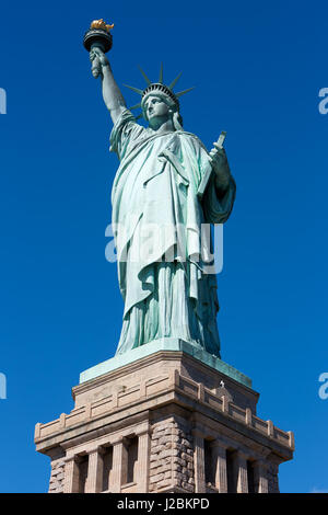 Statue of Liberty and pedestal on clear dark blue sky in a sunny day Stock Photo