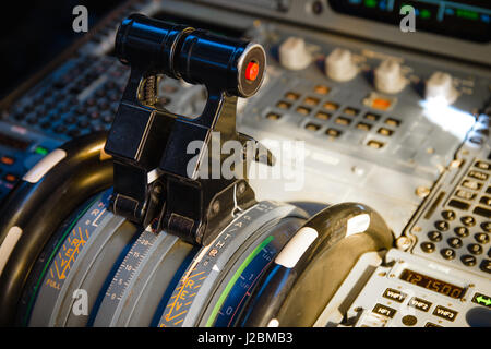 Airbus A320 thrust levers on the centre pedestal instrument panel. Switches and dials visible in the background. Stock Photo
