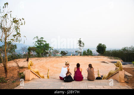 Relaxing atop the hilltop stupa in Luang Namtha, Laos. (MR) Stock Photo