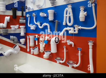 Plastic plumbing, pipes and fittings for sewage system displayed in the store Stock Photo