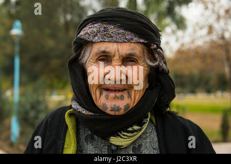 Old Kurdish woman with tattoos in her face in the Martyr Sami Abdul-Rahman Park in Erbil or Hawler, capital of Iraq, Kurdistan (Large format sizes available) Stock Photo