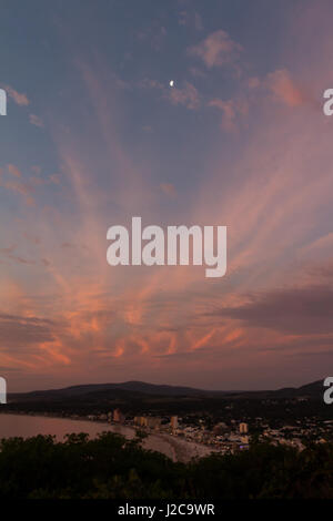 Sun sets and colors the sky with pink, in Piriapolis, Uruguay. Stock Photo