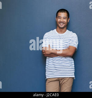 Happy young Asian man with relaxed attitude Stock Photo