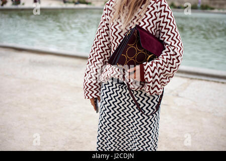 Woman in park wearing zig zag patterned top and skirt, crop Stock Photo