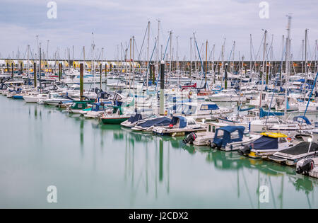 Boats, yachts, and fishing boats moored at Brighton Marina docs on a cloudy day. Stock Photo