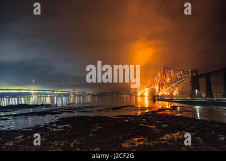 The Forth Rail Bridge and Forth Road Bridge crossings over the Firth River at night. South Queensferry, Edinburgh, Scotland Stock Photo