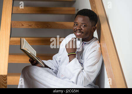 African Muslim Man Making Traditional Prayer To God While Wearing A Traditional Cap Dishdasha Stock Photo