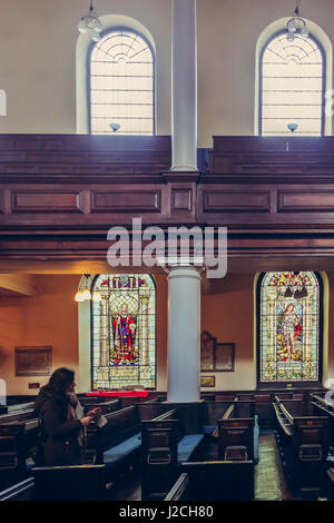 Beautiful stained glass windows and benches of St Anns Church in Manchester, UK Stock Photo