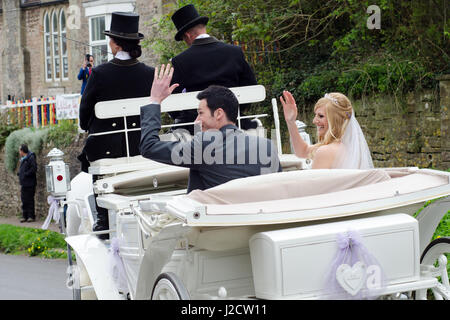 Wedding couple in horse drawn carriage Stock Photo