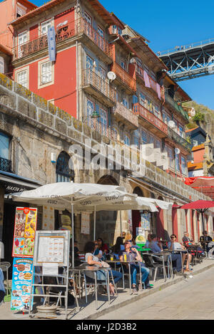 Bar Porto Portugal, view of tourists at a bar in the Ribeira waterfront area enjoy refreshment on a summer afternoon, Porto Europe Stock Photo