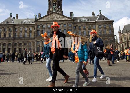 Amsterdam, Netherlands. 27th Apr, 2017. People celebrate the Netherlands' traditional King's Day at the Dam Square in front of the Royal Palace in Amsterdam on April 27, 2017. The Dutch's King's Day is the birthday of the incumbent King or Queen. Credit: Sylvia Lederer/Xinhua/Alamy Live News Stock Photo