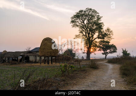 Sunrise over the farm houses of the village Pandavnagar in Chitwan National Park Stock Photo