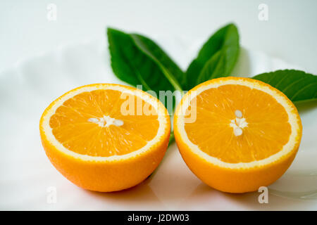 The organic slice orange on white plate - isolated Stock Photo