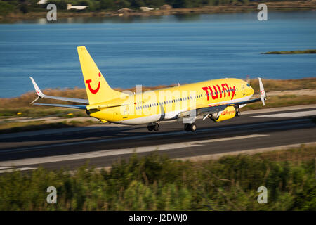 Corfu, Greece - August 18, 2015: TUIfly Boeing 737-800 landing on runway of Corfu International Airport. Stock Photo