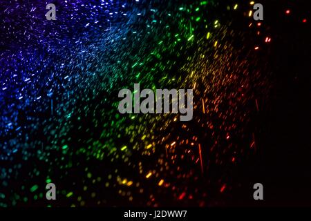 Abstract spectral colours; all of the colours of white light are split by a prism and seen here hanging in the air in a rainbow Stock Photo