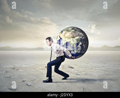 Businessman carrying Earth on his back Stock Photo