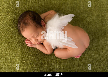 Adorable African newborn baby of 7 days old sleeping on a green blanket Stock Photo