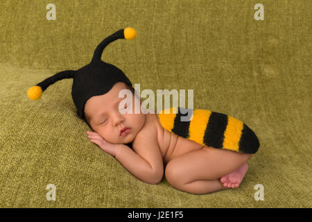 Adorable African newborn baby of 7 days old sleeping on a green blanket Stock Photo