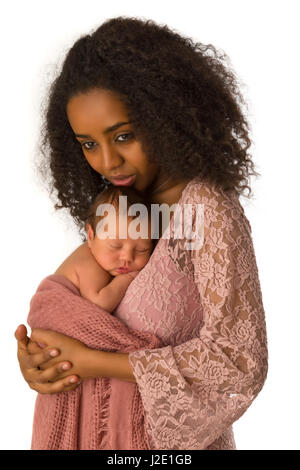 Beautiful African mother in pink lace dress holding her 1 week old little baby Stock Photo