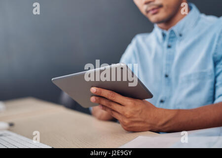 Young designer using a tablet at his office desk Stock Photo